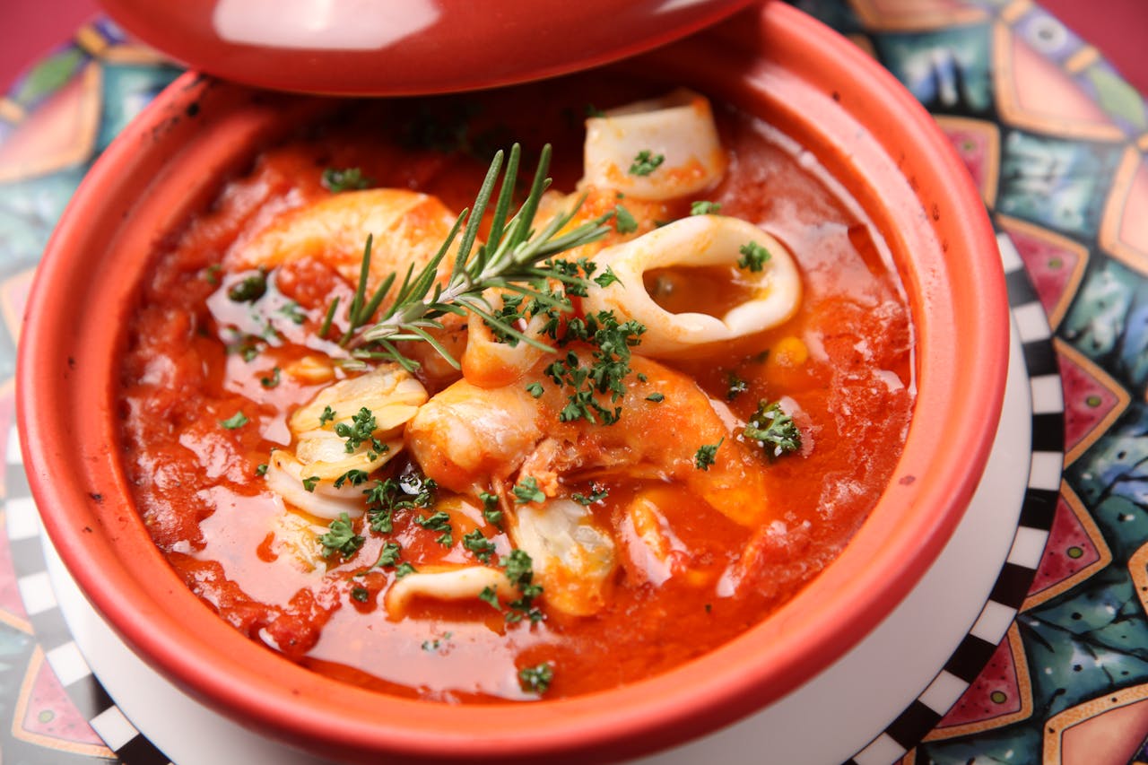 Savor this flavorful seafood stew with squid and shrimp in a rich tomato broth.